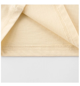 Detailed close-up of double-needle hem and overlock stitching on cotton t-shirt