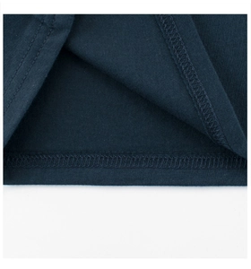 Detailed close-up of double-needle stitching and fabric texture on navy blue kids' t-shirt