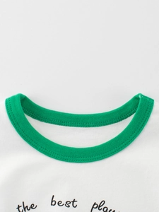Neckline detail of kids white cotton T-shirt with green ribbed trim and dual needle stitching