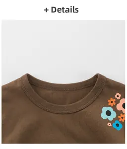 Detailed view of the ribbed crew neck and colorful floral print on kids brown t-shirt