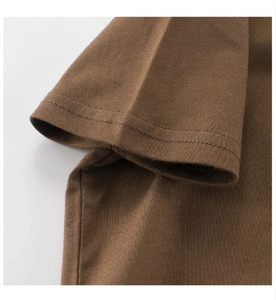 Macro view of brown cotton T-shirt sleeve showing professional double-needle stitching