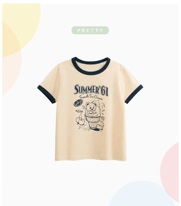 Detail of kids vintage t-shirt featuring cream cotton fabric and retro summer prints