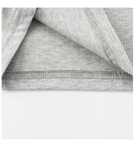 Detail view of double-stitched hem on grey cotton t-shirt for girls with high quality finish