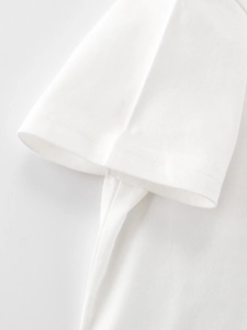 Detailed close-up of double-needle stitching on white cotton kids t-shirt sleeve
