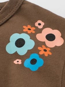 Dark brown cotton kids T-shirt featuring a colorful floral print and soft knit texture