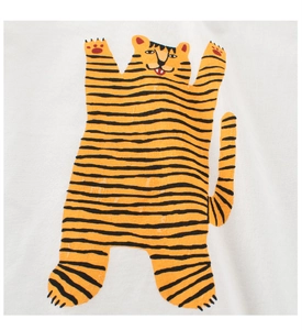 Detailed close-up of a stylish orange cartoon tiger print on a white fabric t-shirt