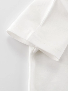 Close-up of white cotton t-shirt sleeve with detailed double-needle stitching and fabric texture