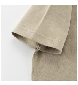 Detailed close-up of double-needle stitching on khaki cotton t-shirt sleeve hem