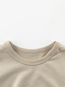 Close-up of khaki cotton short sleeve T-shirt featuring a ribbed crew neck and fine stitching