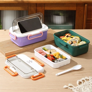 Three-compartment bento box with phone stand lid, utensils, and stylish color contrast
