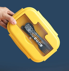 Handheld view of Morandi dual-compartment lunch box with built-in utensils and lid