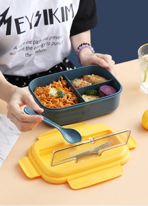 Close-up of portable blue bento box with three compartments and phone stand lid