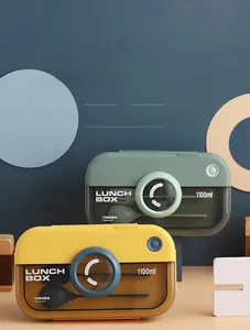 Detail of camera-shaped lunch boxes with translucent lids and internal spoon storage