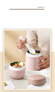 Detail view of pink stainless steel soup cup with lid and white foldable spoon