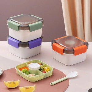 Detail view of leak-proof plastic lunch box with colorful buckles and internal divider tray