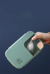 Detail showing leak-proof mint green lunch box with cutlery set and transparent lid