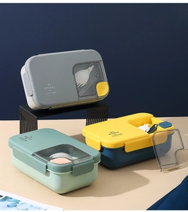 Three-color partitioned bento boxes with cutlery storage lids and matching spoons