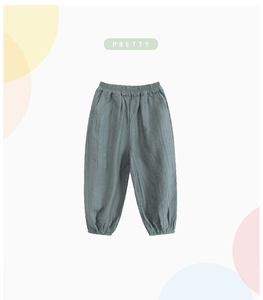 Detail of children's grey-blue mosquito pants with elastic waist and textured fabric