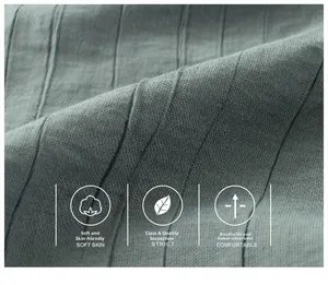 Close-up of grey pleated fabric detail for kids' trousers showing breathable texture