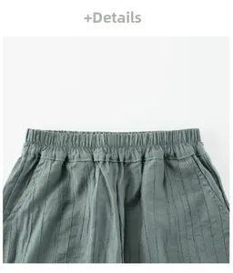 Detail of grey-green elastic waist pants with vertical texture and cotton-linen fabric