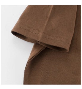 Detail shot of sleeve cuff and side seams on dark brown cotton t-shirt with flat stitching