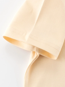 Détail de la manche d'un t-shirt en coton crème avec double couture plate précise