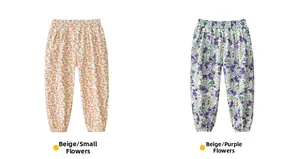Detail view of cotton floral mosquito pants in cream orange and purple flower patterns