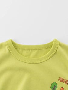 Green kids cotton T-shirt featuring a round neck and cute cartoon apple print