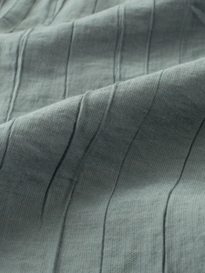 Close-up of breathable grey-blue mosquito pants fabric with vertical striped texture