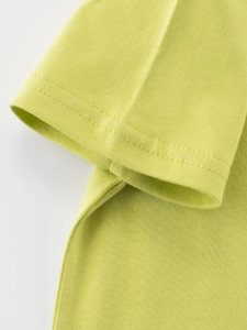 Detailed view of neon green cotton T-shirt sleeve with high-quality stitching