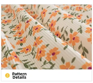 Detail view of ribbed cotton fabric featuring delicate orange floral prints for kids pants