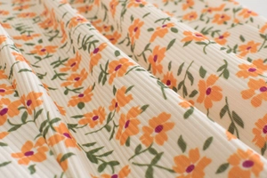 Close-up of baby mosquito pants with floral print and ribbed texture fabric detail