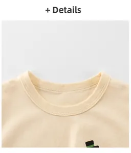 Detailed close-up of a ribbed neckline on a soft cotton cream-colored kids' cartoon T-shirt