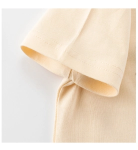 Detailed view of cream rib-knit fabric texture and double-needle cuff stitching details