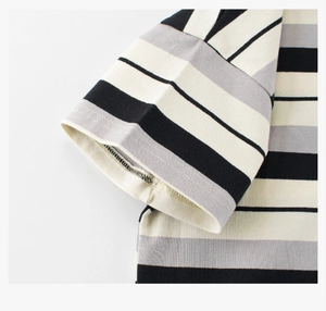 Close-up of neatly stitched sleeve cuffs on a striped cotton t-shirt for children