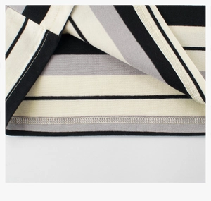 Detail view of double-needle stitching on striped knit sleeve and hem edges
