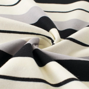Macro detail of soft striped knit cotton fabric with black and cream textures