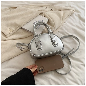 Detail of silver metallic bowling bag showing mini size relative to a smartphone