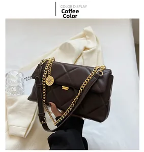 Close-up of coffee brown quilted crossbody bag with gold chain and leather strap