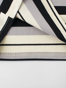 Close-up of kids striped cotton T-shirt featuring neat double-needle hem stitching detail