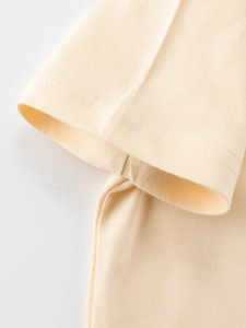 Pale yellow cotton kids T-shirt showing high-quality double-needle cuff stitching detail
