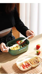 Detail view of large capacity divided lunch box with built-in cutlery and carrying handle