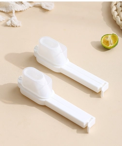 Detail of white food bag sealing clips with pouring spouts for snack preservation