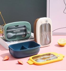 Japanese-style lunch box detail showing colorful lids and cutlery storage compartments