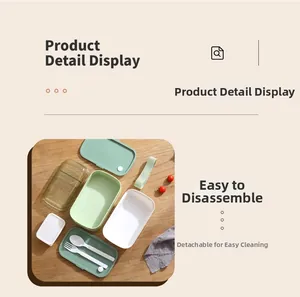 Close-up of detachable bento box layers with portable strap and reusable cutlery set