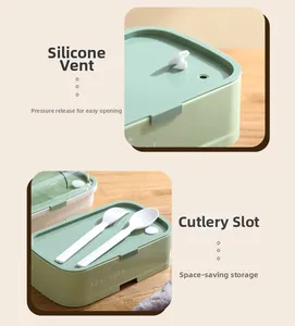 Detail of green bento box showing the silicone air vent and cutlery storage slot