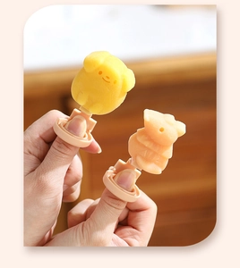 Close-up of cute animal-shaped DIY silicone ice cream popsicles with ring handles