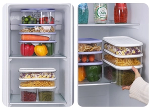Detail of hand grabbing a stackable clear PET food storage box with airtight lid in fridge