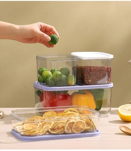 Close-up of clear PET food storage containers with airtight lids on a wooden tabletop