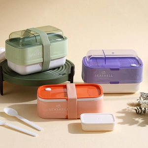 Three-tier stackable bento lunch box set with elastic straps and matching utensils